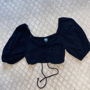 Black cropped puffed sleeved top. Tie on the front and two holes.